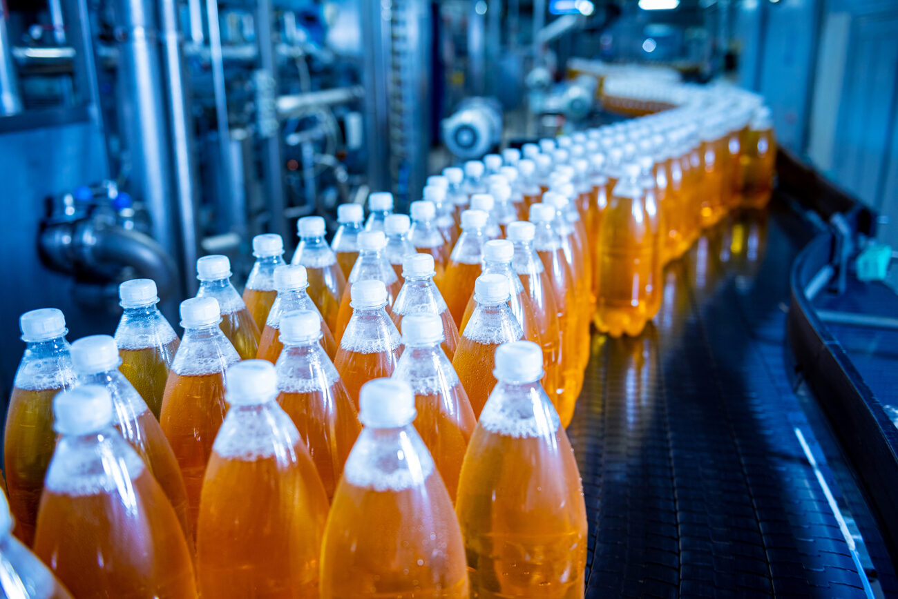 Conveyor Belt With Bottles For Juice Or Water At A Modern Beverage Plant